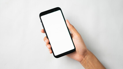 Hand holding blank screen smartphone isolated
