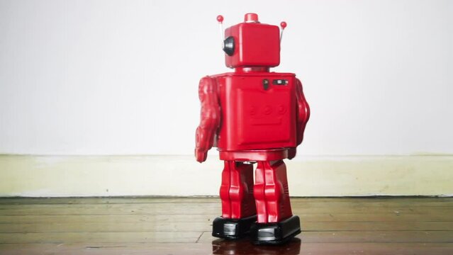 bright red vintage robot on old wooden floor 