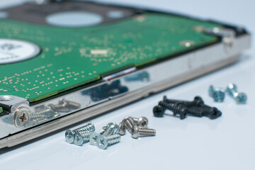 Micro screws with white background and hard disk