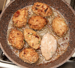 Minced meat cutlets are fried in a frying pan