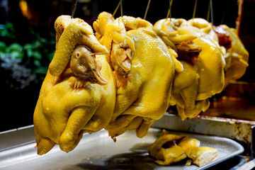 Three steamed chickens on rack
