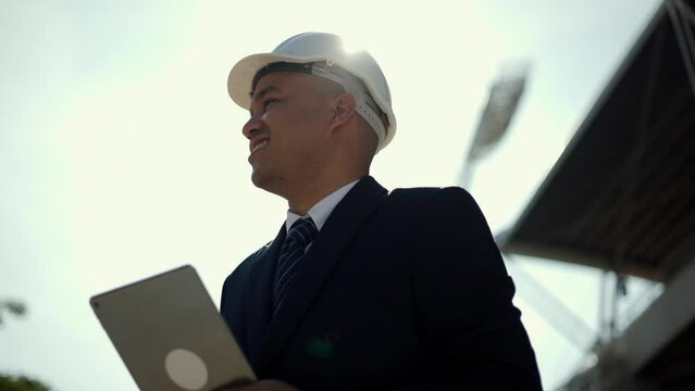 Real estate project manager or architect looking using tablet for checking and consultant to inspection in construction site building. Middle eastern Boss CEO, business owner Real estate property