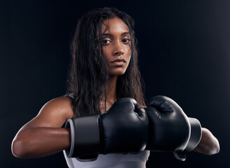 Portrait, woman and boxer with fitness, serious and ready for match, confident and dark studio background. Face, female athlete and lady with gloves, training or endurance for energy, strong or power