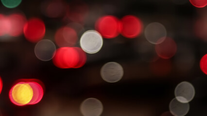 Blurred defocused image of evening car traffic in a big city. Cars in motion and standing in traffic jams. Long exposure exposure and headlight trails