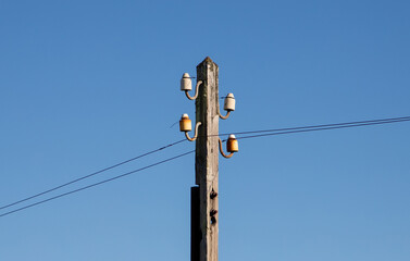 A close-up of an old wooden telephone pole