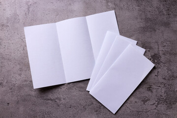 Trifold white template paper for mock up on gray rustic background