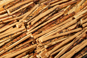 Pretzel bread sticks with sesame seeds. Delicious pretzels in bulk. close up