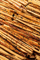 Pretzel bread sticks with sesame seeds. Delicious pretzels in bulk. close up