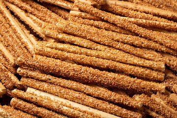 Pretzel bread sticks with sesame seeds. Delicious pretzels in bulk. close up
