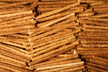 Pretzel bread sticks with sesame seeds. Delicious pretzels in bulk. close up