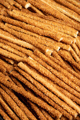 Pretzel bread sticks with sesame seeds. Delicious pretzels in bulk. close up