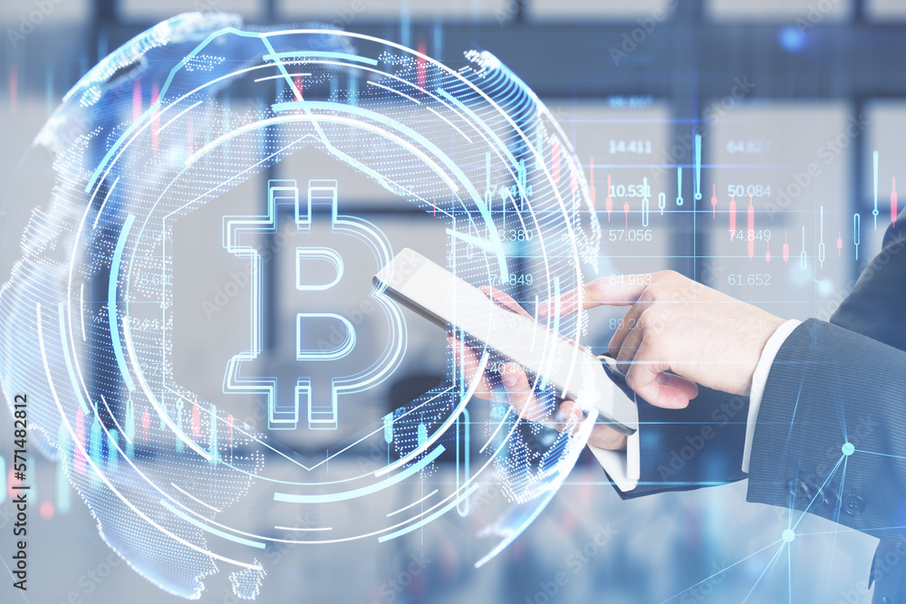 Poster close up of businessman hands using mobile phone with glowing bitcoin hologram on blurry office inte