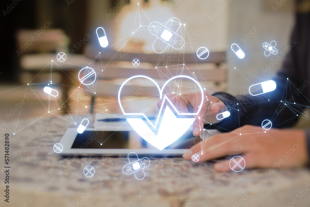 Poster side view and close up of female hands using tablet with glowing heart hologram on blurry background