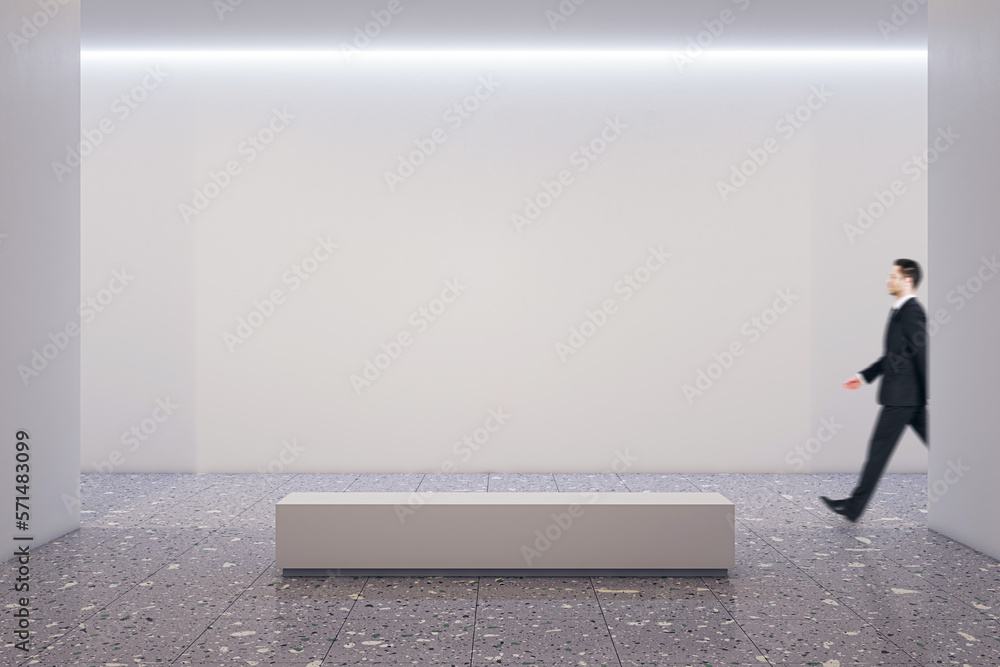 Poster side view on walking businessman by white blank wall background with place for advertising poster or