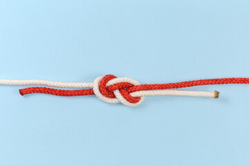 Rope knot Flemish bend on a blue background