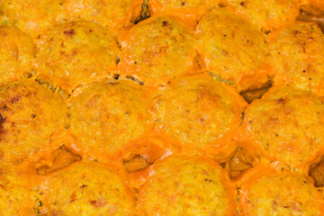 Baked meatballs with rice in baking tray, fragment close-up