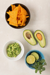 Ingredients for making guacamole on a light background, top view