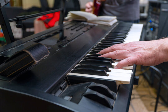 A Pianist Or Keyboardist Plays A Synthesizer