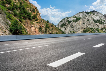 Asphalt road with mountain natural scenery in Xinjiang, China.