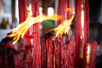 Close-up of the flames from the Chinese candles at the Buddha shrine in a Chinese temple located in Thailand.