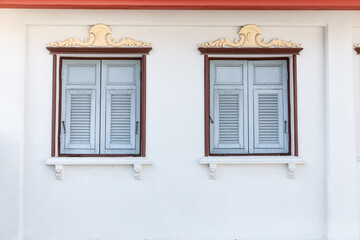 Antique wooden windows that are commonly found in Bangkok's old town.