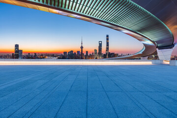 Empty square floor and bridge with city skyline at sunrise in Shanghai, China. - obrazy, fototapety, plakaty