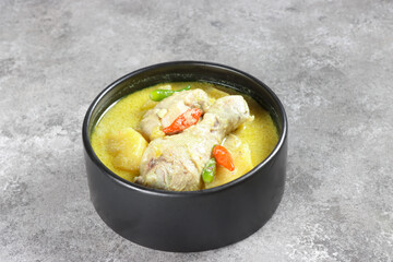 Ayam Masak Lemak Cili Api Dengan Nenas is Chicken with Pineapple in Spicy Coconut Milk Soup. Malaysian Traditional Dish from Negeri Sembilan.