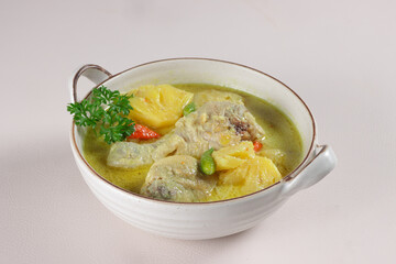 Ayam Masak Lemak Cili Api Dengan Nenas is Chicken with Pineapple in Spicy Coconut Milk Soup. Malaysian Traditional Dish from Negeri Sembilan.