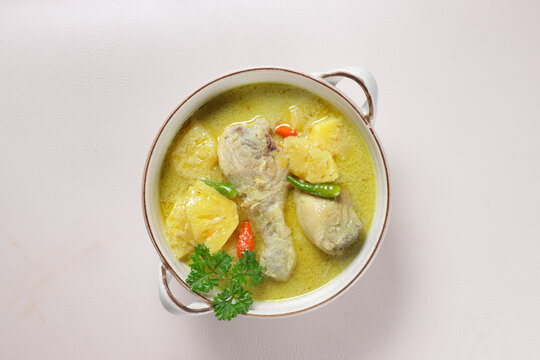 Ayam Masak Lemak Cili Api Dengan Nenas is Chicken with Pineapple in Spicy Coconut Milk Soup. Malaysian Traditional Dish from Negeri Sembilan.