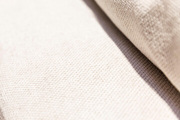 The surface of a classic light upholstery fabric. Modern interior design and textiles. Close-up. Space for text. Selective focus. Background.