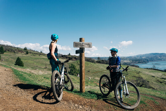 Two young women take a break while mountain biking in Washington State