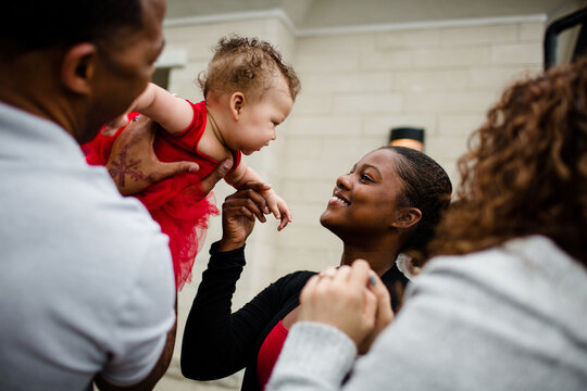 African American Step Sister Smiling at Biracial Baby Sister