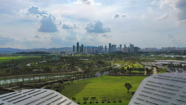 Passing through the Four Seasons Exhibition Greenhouse at the Sejong National Arboretum in Sejong City, Korea, you can see the whole view of the arboretum and an apartment building in Sejong City unde