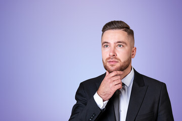 Businessman with hand to chin, pensive portrait on copy space ba