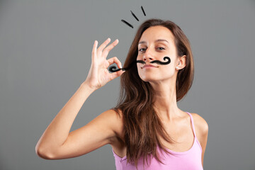 Woman with OK gesture, drawn moustache, symbolizing Italian/Fren - obrazy, fototapety, plakaty