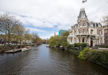 Fototapeta na wymiar Traditional historic Dutch gable houses beside canal in Amsterdam The Netherlands