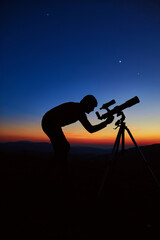 Man with astronomy telescope looking at the night sky, stars, planets, Moon and shooting stars.