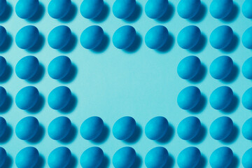 Blue easter eggs on blue background. Table top flat lay shot.
