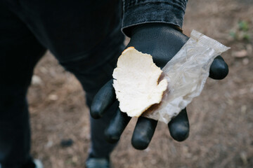 activist showing garbage found in the forest during the solidarity collection