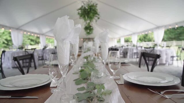 Elegant banquet tables for ourdoor wedding. Big tent, lots of opulence. Zoom in. 