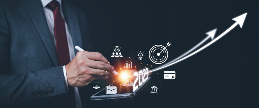 2023 and Startup concept with icon business and network connection on modern virtual interface from digital tablet.Businessman Touching tablet and graph Screen Icon of media screen, Technology Process