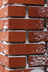 Obraz premium Brick partially covered with fresh snow.