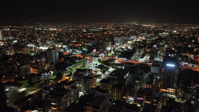 Santo Domingo City Illuminated With Lights At Night In Dominican Republic - aerial drone shot