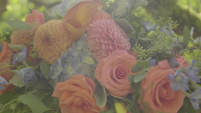 Flower arrangement for a elegant wedding. Zoom in. Roses, marigolds, hydrangea. Flare.