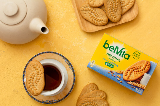 Tiraspol, Moldova - January, 31, 2023: BelVita breakfast cereals cookies box with smak Milk, cookies on plate and tea on orange background. Selective focus, top view
