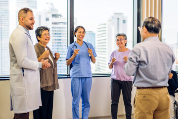 Fototapeta premium Portrait of asian woman physiotherapist trainer carer helping physical and discussing consulting talk with group asian senior patient by doing yoga workout exercises in rehabilitation at hospital