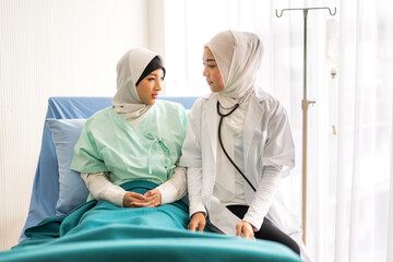 Muslim asian woman doctor service help support discussing and consulting talk to muslim woman patient at meeting health medical care express trust concept in hospital.healthcare and medicine