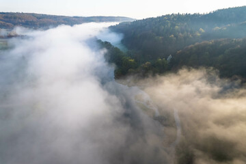 Fog covers the mountain forest. Mountain inversion. Highlands under the fog. Foggy sunrise in the mountains. Aerial view of fog-covered forest.