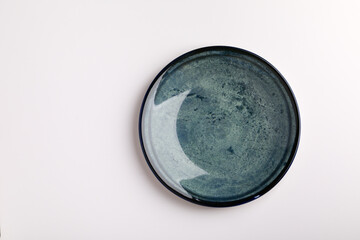 Plate on the white background. Blue plate.