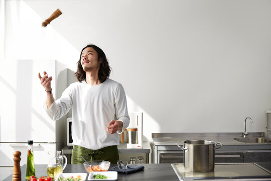 ペッパーミルをジャグリングする男性